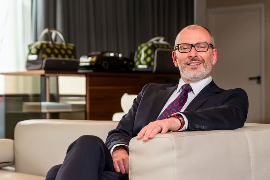 Man in suit and glasses smiling for photo