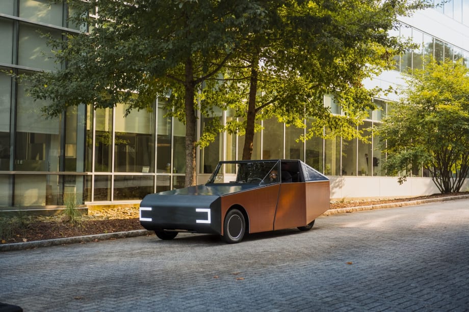Orange BMW car on empty road.