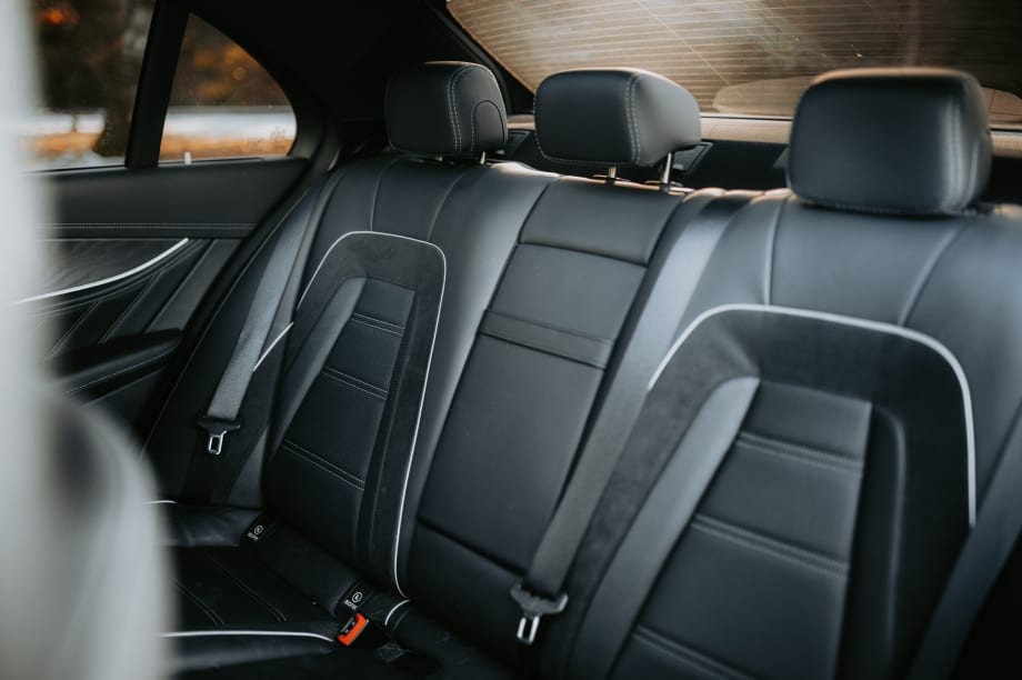 Black leather with white trim back passenger seats.