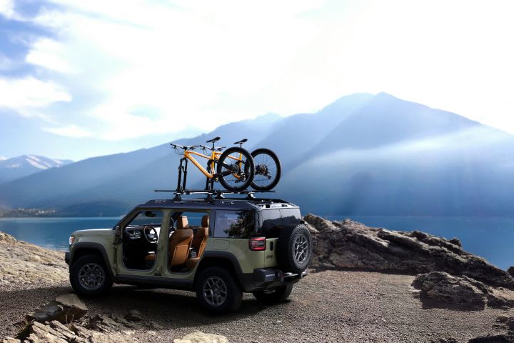 Photo of a parked Jeep Recon with a mountain peak in the background