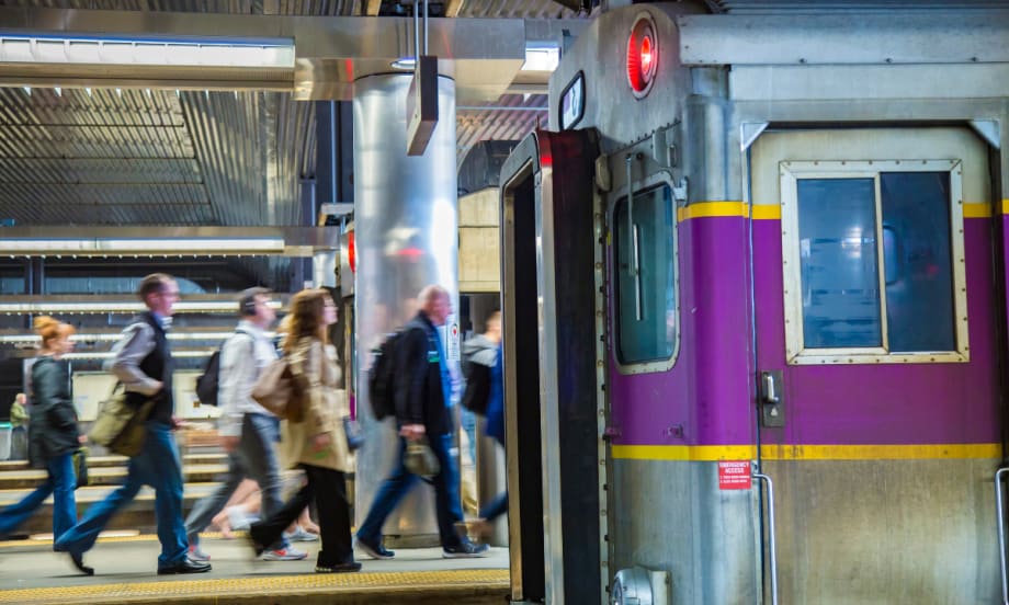 MBTA rail platform with people walking by.