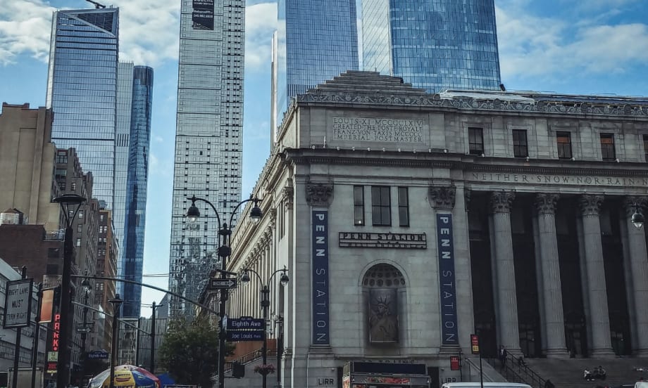 A scene of Penn Station with Hudson Yards skyscrapers in the background in New York City.