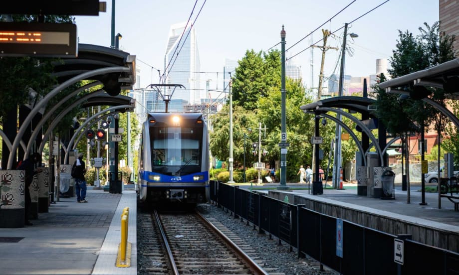 Charlotte Area Transit System's light rail pulling in to a station.