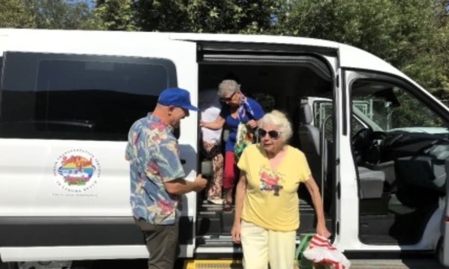 Seniors exiting an OCTA van.