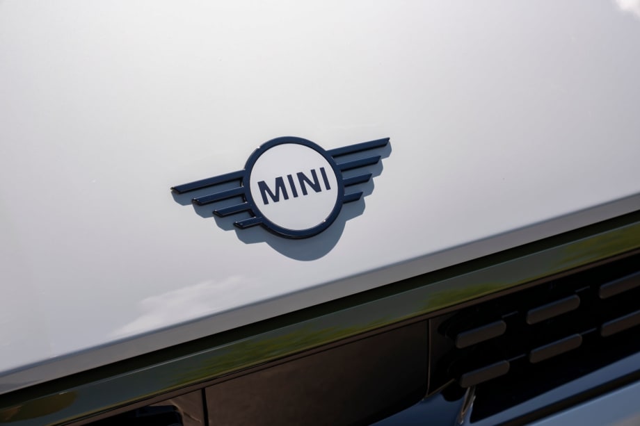 Photo of MINI nameplate on the hood of a white MINI Cooper