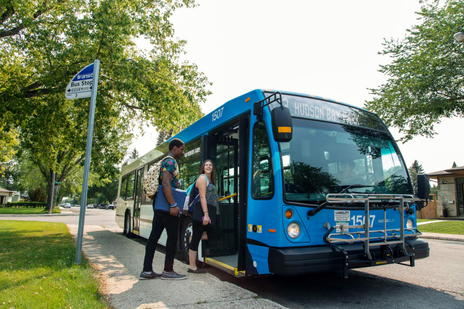 Passenger boarding Saskatoon Transit bus.