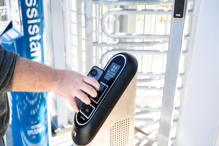 A rider validating a tap payment on a Masabi validator.