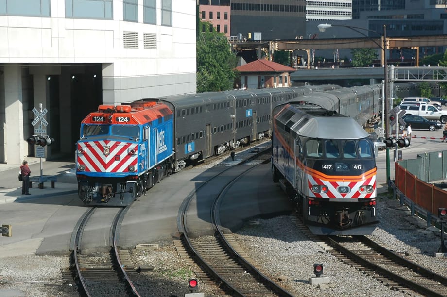 Two Metra locomotives on rail tracks.