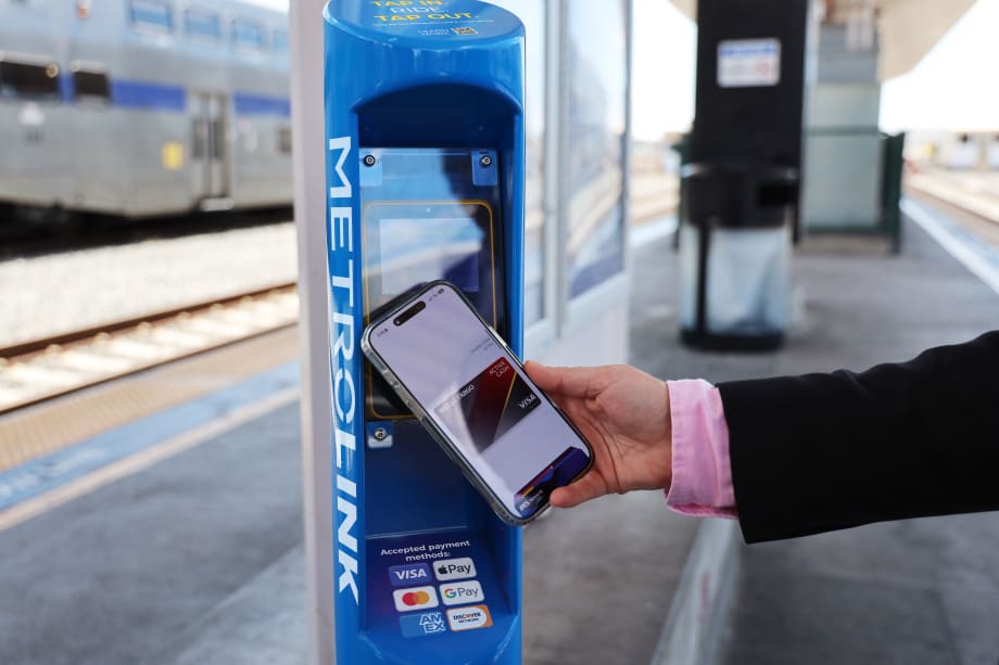 A user demonstrating Metrolink's contactless fare payment pilot.