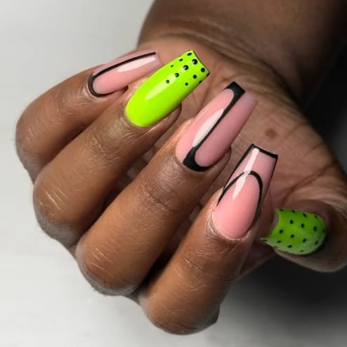 A manicure of pink and green polish.