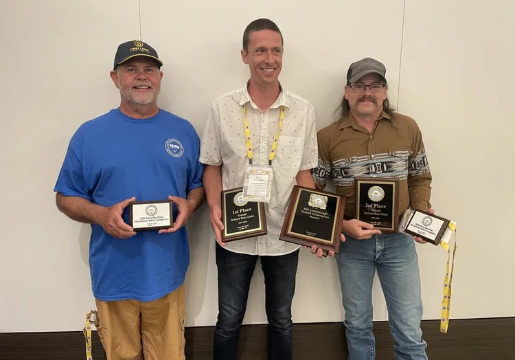 Three Oregon school bus drivers stand side by side holding plaques after the School Bus Driver International Safety Competition. From left are Marcos Valdes of Beaverton, Brian Rickmann of Beaverton, and Kevin Beck of Salem-Keizer.