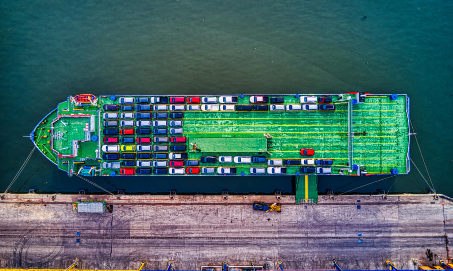 cargo ship with vehicles, at dock