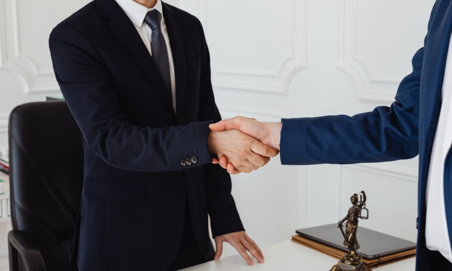 two men in suits shaking hands