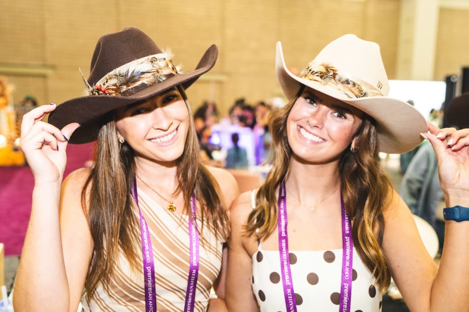 Two women wearing cowboy hats