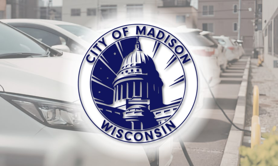 City of Madison, Wisconsin seal overlaid on an image of electric vehicles parked and charging in a row.
