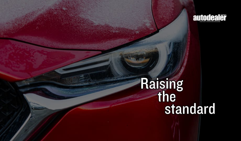 red Mazda headlight/bumper, Raising the standard, Auto Dealer Today logo in white