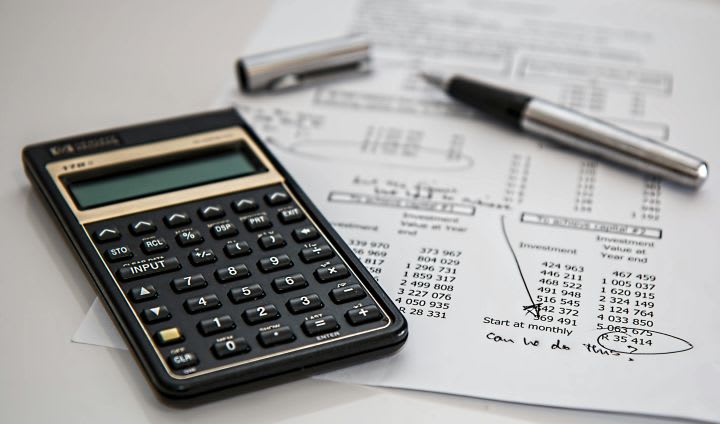 Photo of document next to calculator and inkpen
