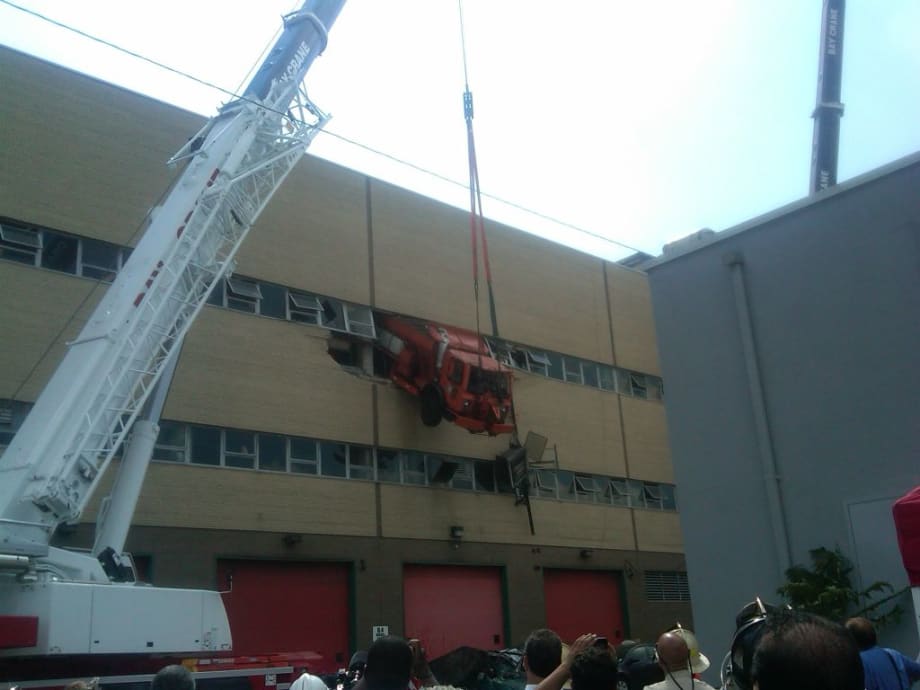 NYC Sanitation Dept. Truck Crashes Through Third Floor Wall of Repair Shop