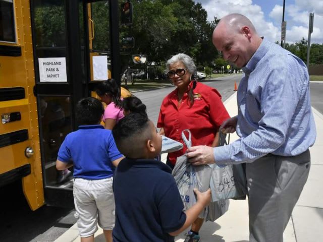 School Bus Drivers Distribute Free Books to Students