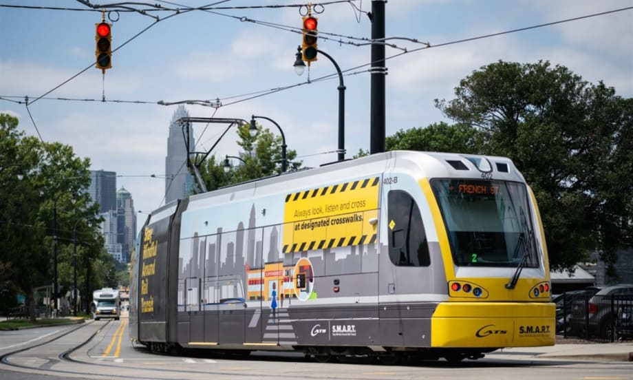 The CATS Gold Line in service with the city skyline in the background.