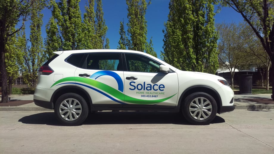 White Nissan Rogue with Solace Health Care branding