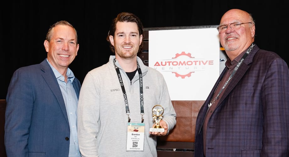 Photo of two men representing winning company, along with the award presenter