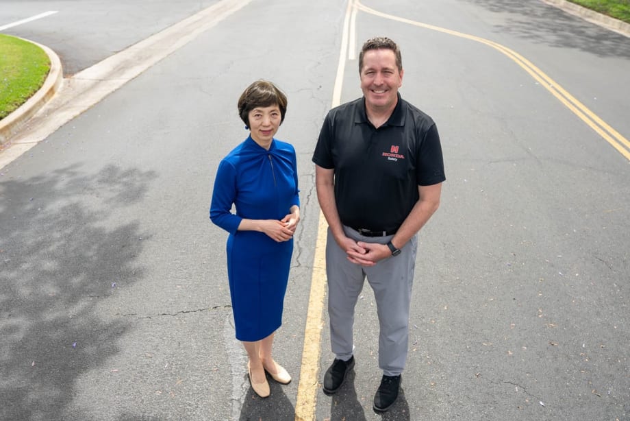 Sue Bai and Brian Bautsch standing on a road