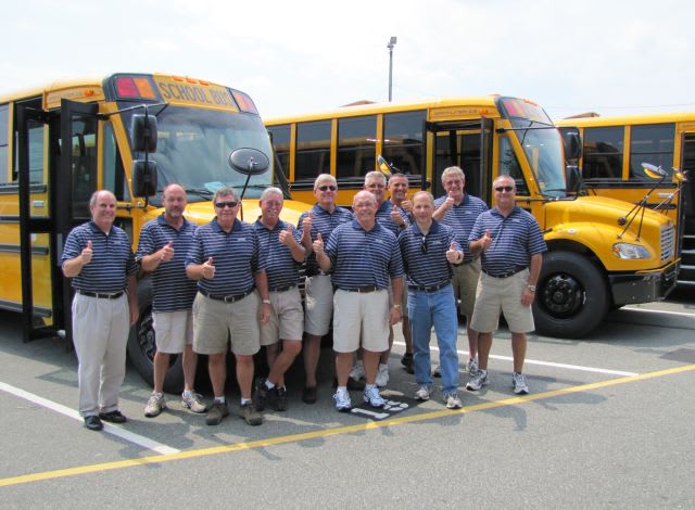 Thomas Built employees carry out bus delivery