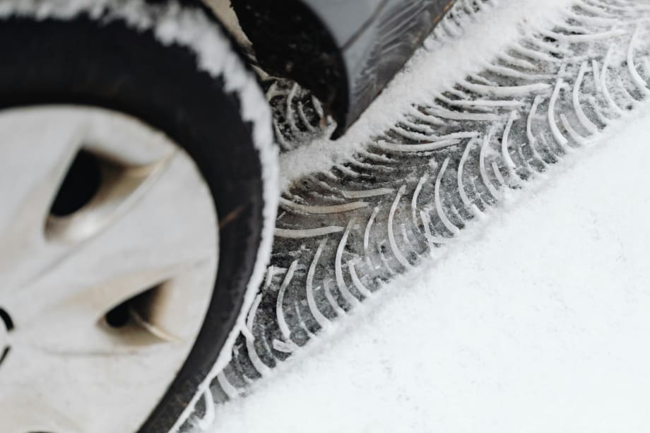 Photo of car tire and the tread mark it left in snow