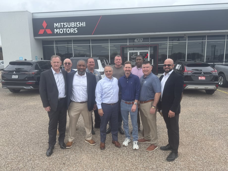 Photo of buyer and seller representatives in Waco Mitsubishi sale outside the dealership