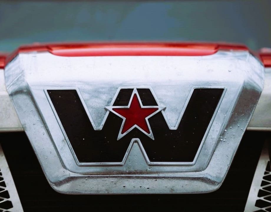 Close-up of Western Star truck logo with red star emblem on chrome grille, representing the brand’s identity in the trucking industry.