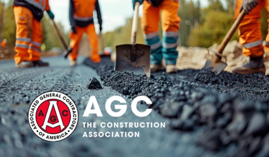 Construction workers are laying asphalt on the road.