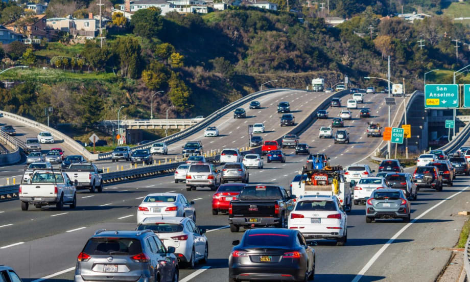 Car driving on a highway during the day.