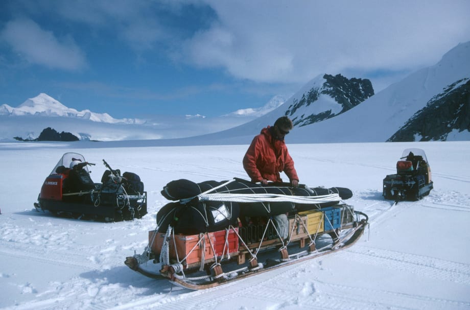 Explorer in Arctic packs sled.