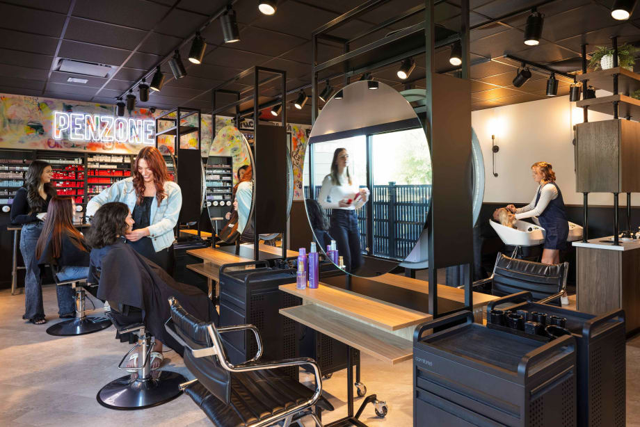 Multiple stations, a shampoo area and a color bar make up the training salon within BASE ONE in Columbus, Ohio.