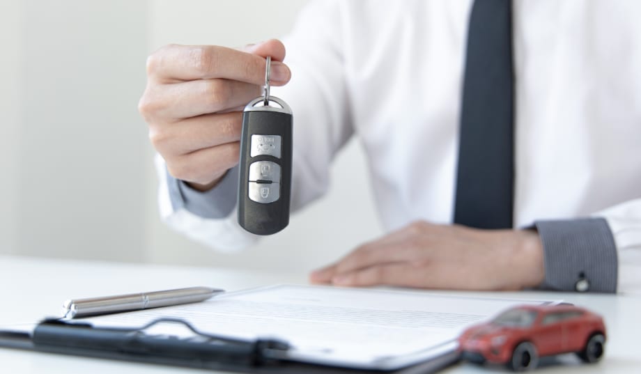 man holding up car keys