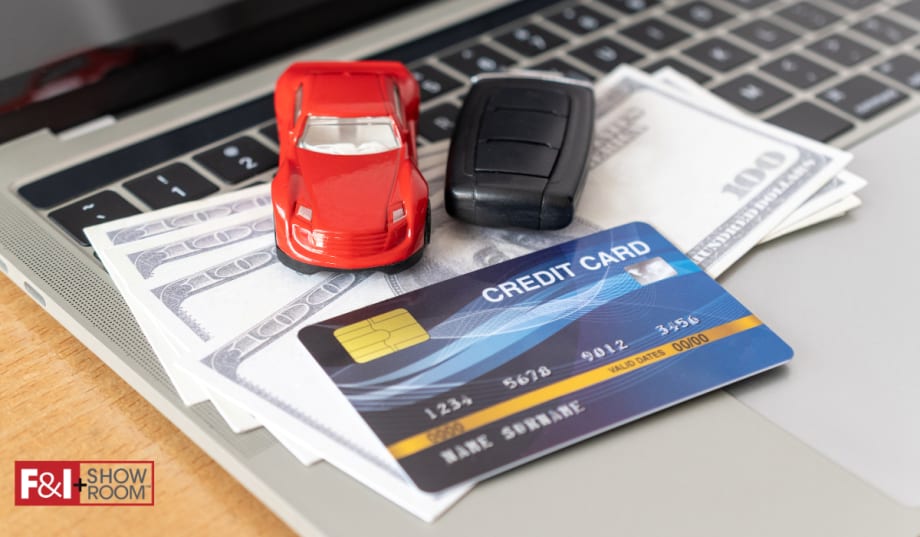 credit card, cash, toy car, car keys on top of laptop