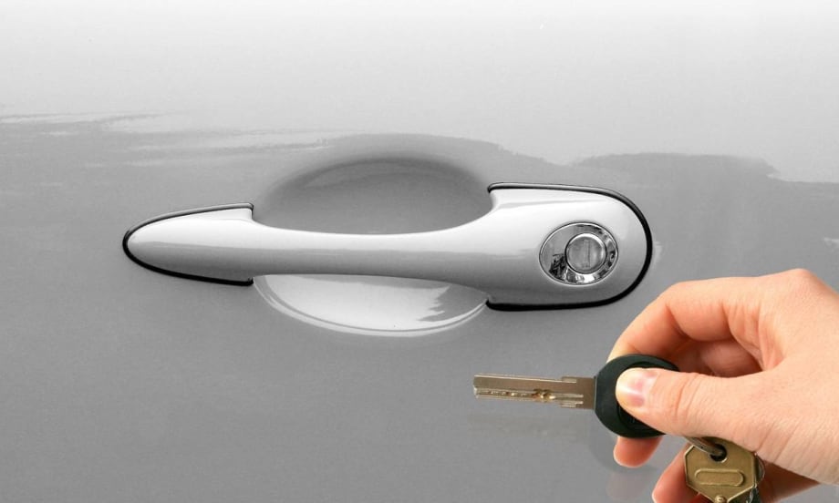 Car key next to keyhole.