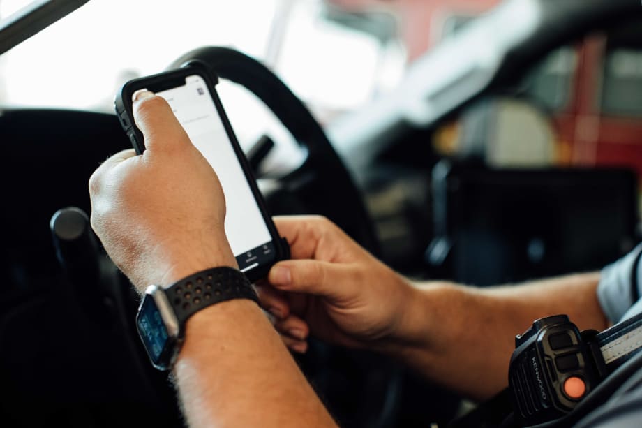 A man holding a phone in a truck.