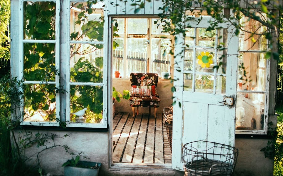 A chair inside a shack.