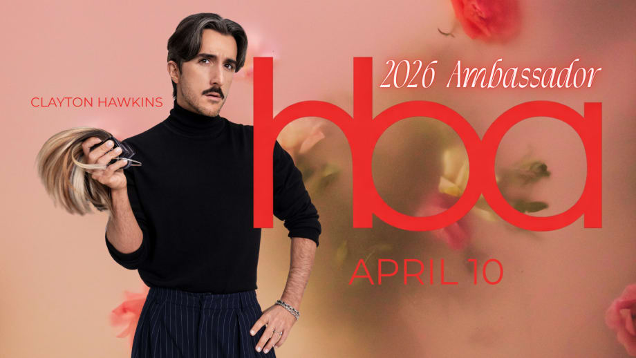 A man in a black turtleneck, holding hair extensions.