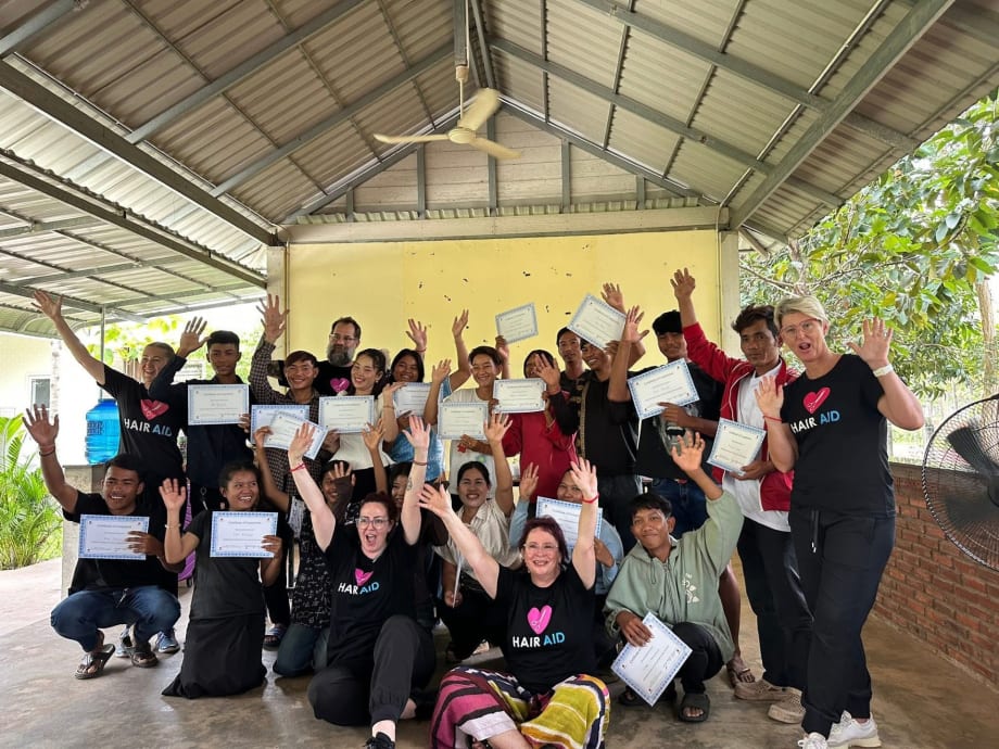 A group of people raising their hands.