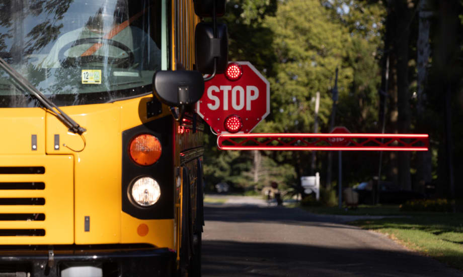 A BusGates extended stop-arm actively in use on a school bus.