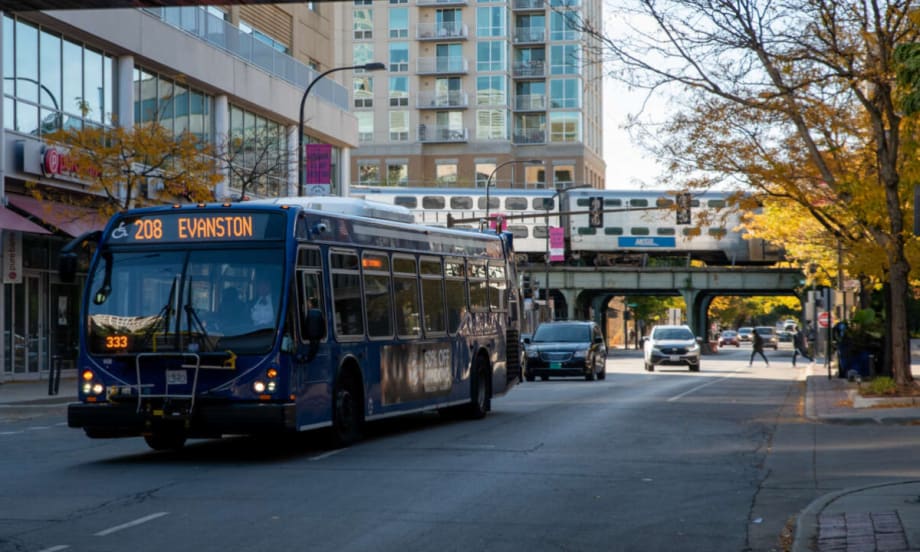 A blue bus on a city street.