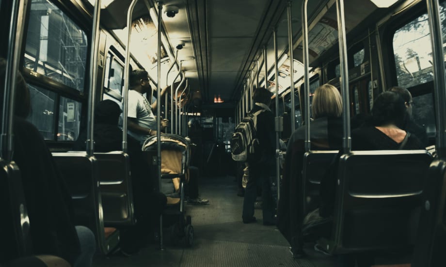 Rides on a public transit bus.