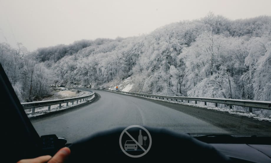 car driving down snowy road