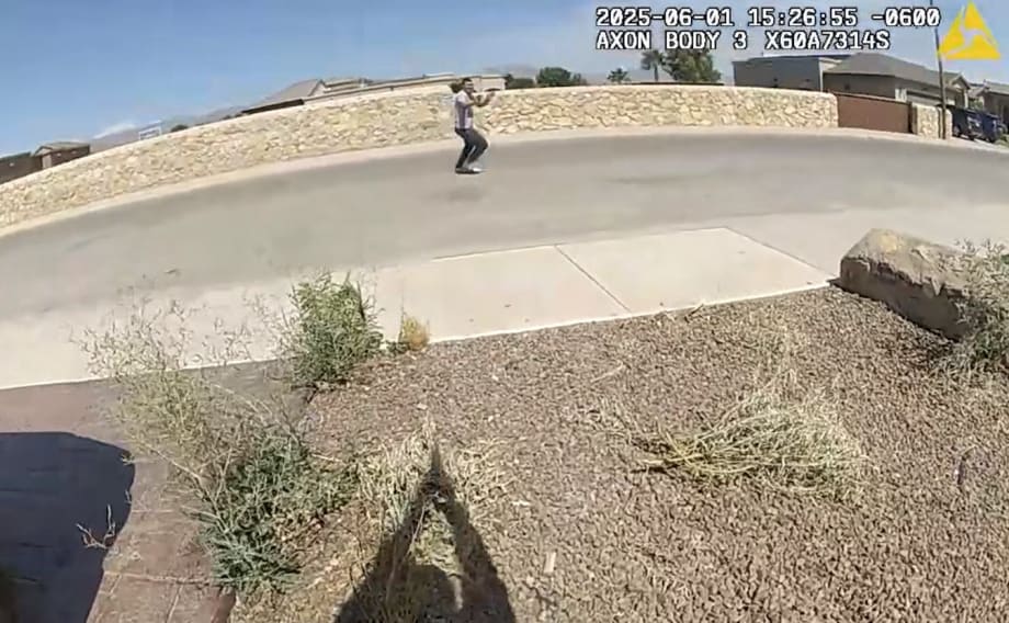 Body camera view of person walking on concrete path near stone wall on sunny day
