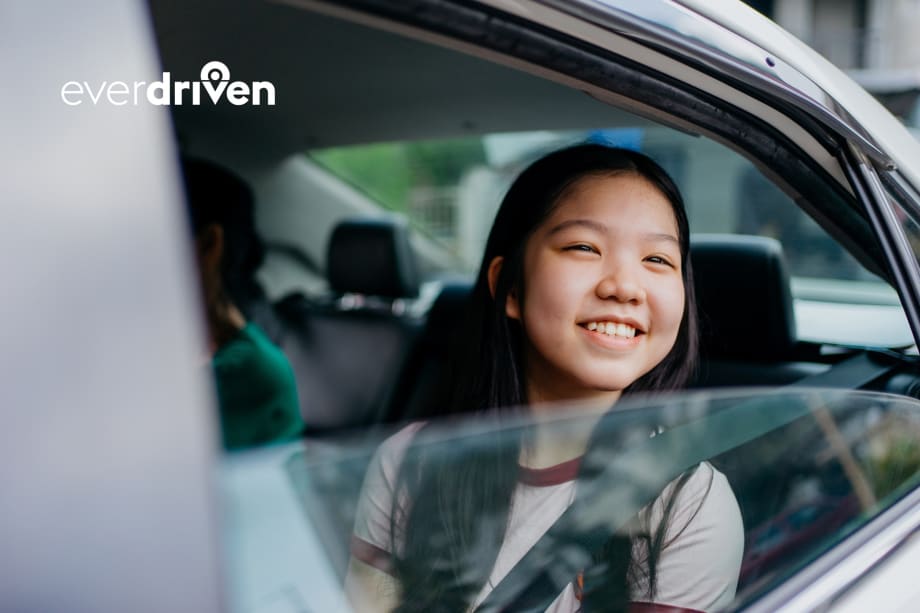 a girl sits in the backseat of a passenger car