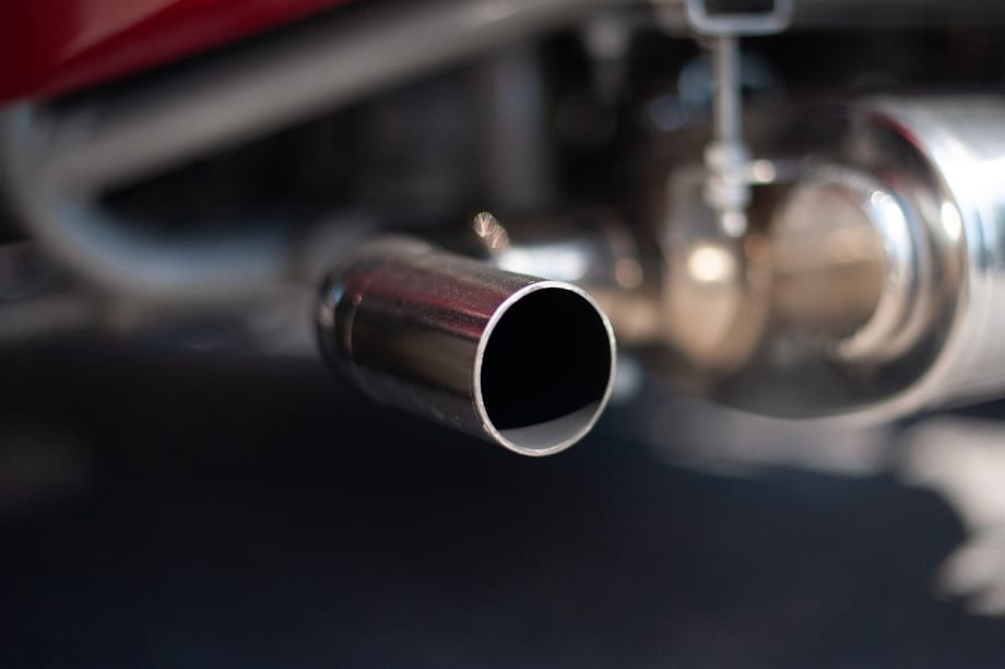Photo of exhaust pipes of older car.