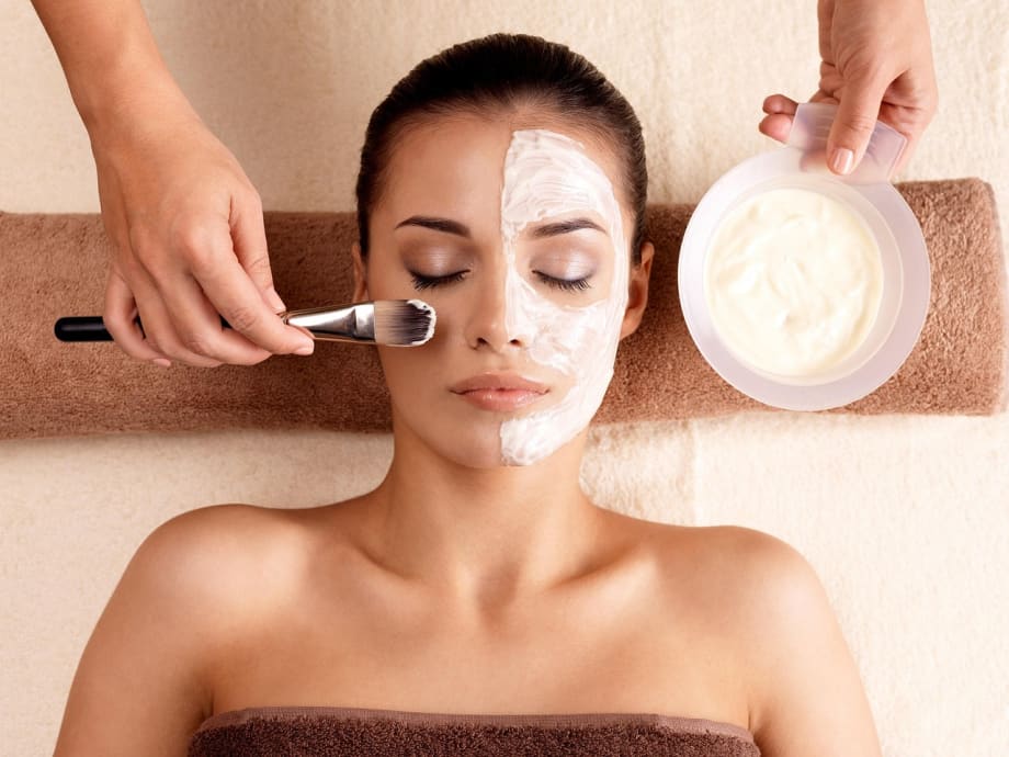 A woman receives a facial treatment.